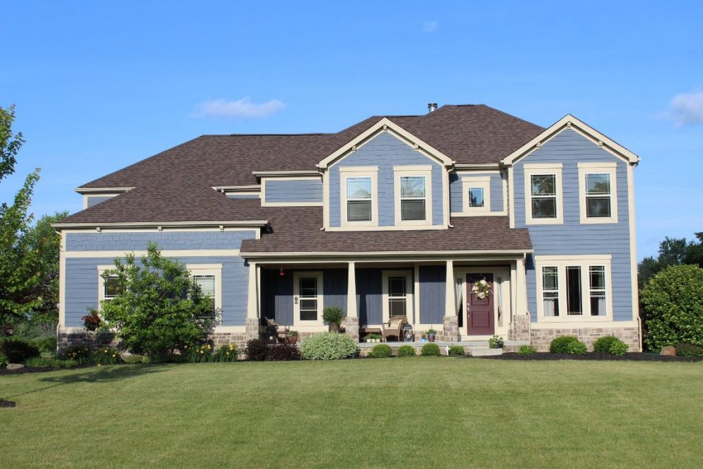 Roofers ohio blue home with asphalt roof