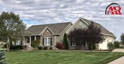 roofers near me Mansfield Ohio home with roof replacement and tan siding contractor installation