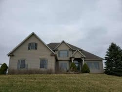 roofing contractors near Ashland Ohio home with storm damaged roof and vinyl siding