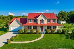 metal roofing ashland ohio home with red metal roof and tan vinyl siding
