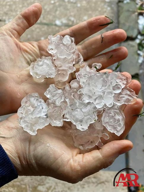 roofing mansfield ohio two hands holding large chunks of hail