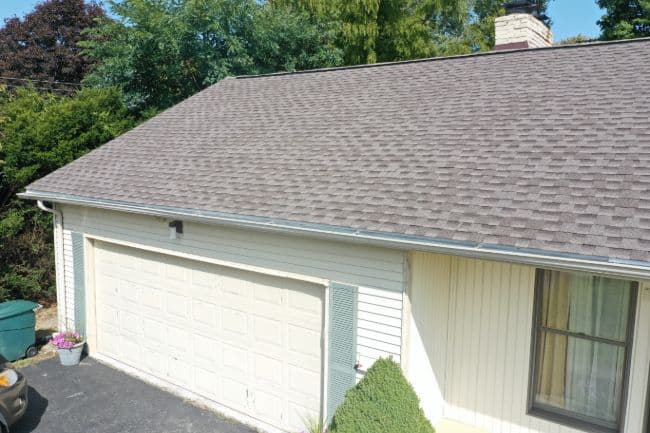 roofers in Mansfield Ohio roofing project home with new shingle roof and white vinyl siding