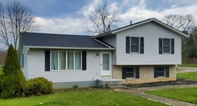 new gray roof installation on home with white vinyl siding by roofing contractors in Mansfield Ohio