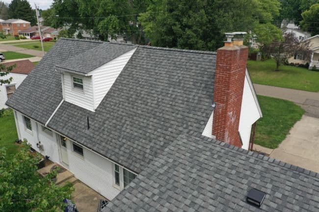 elevated rear view of new roof installation on home done by roofers