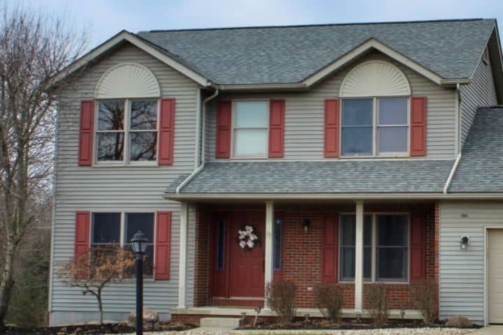 exterior of home with gray siding and new roof redone by shelby roofers
