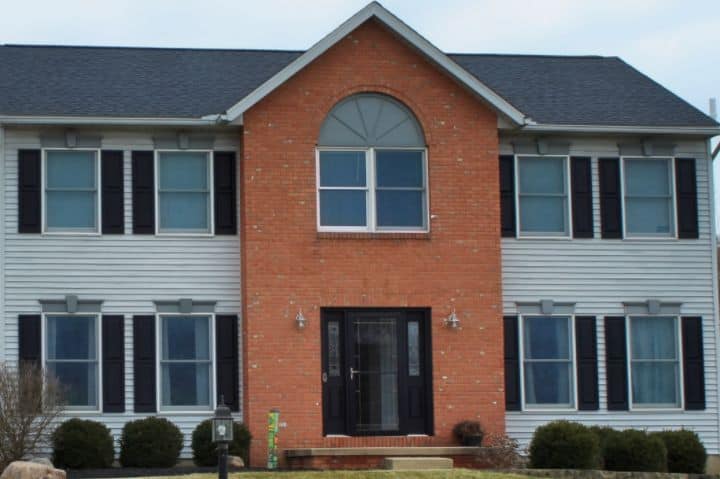 new roof install by roofing companies in Mansfield Ohio and new gray siding installation